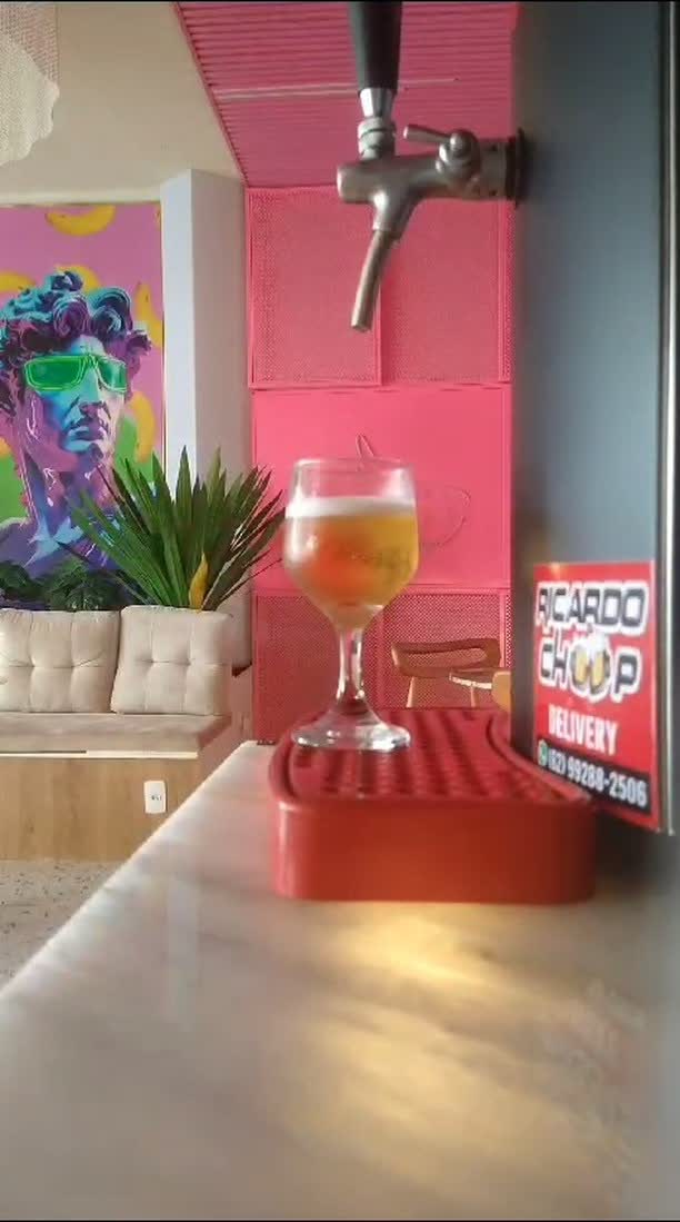 Torneira de chopp servindo taça em bar